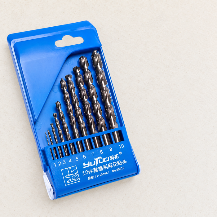 Blue case holding ten twist drill bits on an ivory workbench