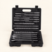 Open black case with drill bits and chisels on an ivory surface