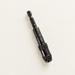 Dark metal drill extension rod on an ivory work surface