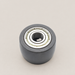 Small dark roller with a metal bearing on an ivory workbench.