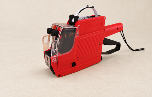 Red manual price labelling machine on an ivory surface.