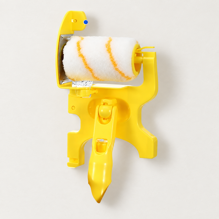 Yellow corner paint roller with striped white sleeve on an ivory surface