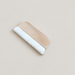 Wide wooden wool paint brush on an ivory surface