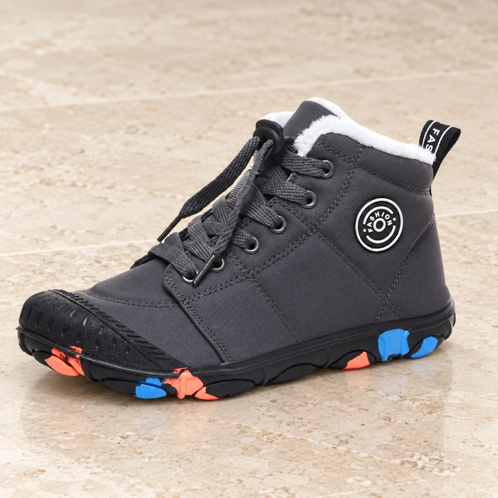 Black high-top children's shoe with laces, white lining and blue and orange sole accents on a neutral stone surface.