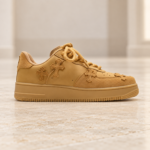 Wheat-coloured sneaker with stitched cross appliques on pale stone.
