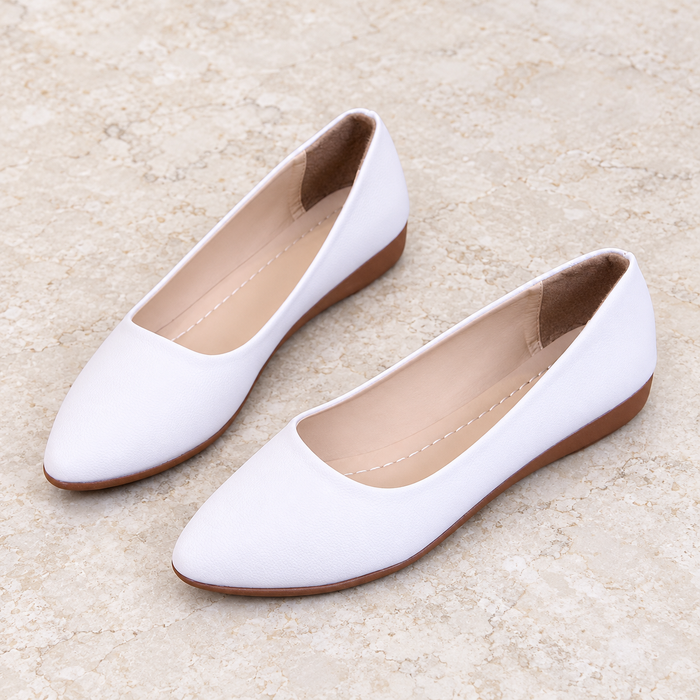 White low wedge shoes with brown soles on ivory stone