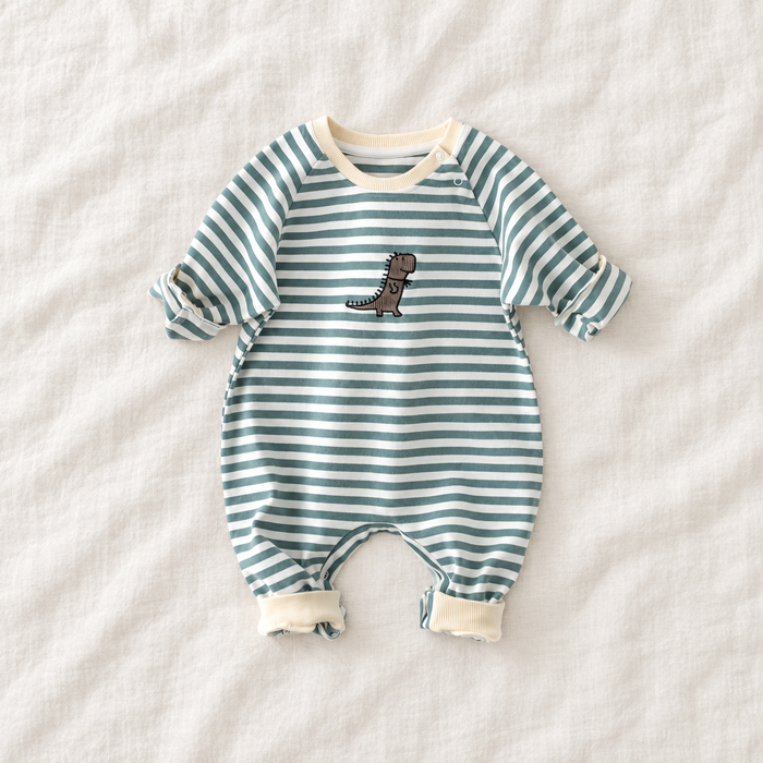 Green and white striped baby jumpsuit with a small dinosaur motif