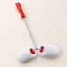 Double white paint roller with red handle resting on ivory worktable