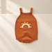 Rust knitted baby romper with a white and mustard rainbow on ivory