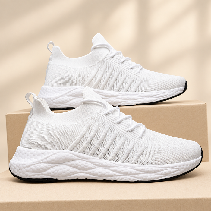 White fabric sneakers on neutral boxes against ivory background