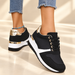 Black gold and white sneakers worn against ivory background
