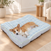 Pale blue plaid pet bed with a resting corgi on a light oak floor