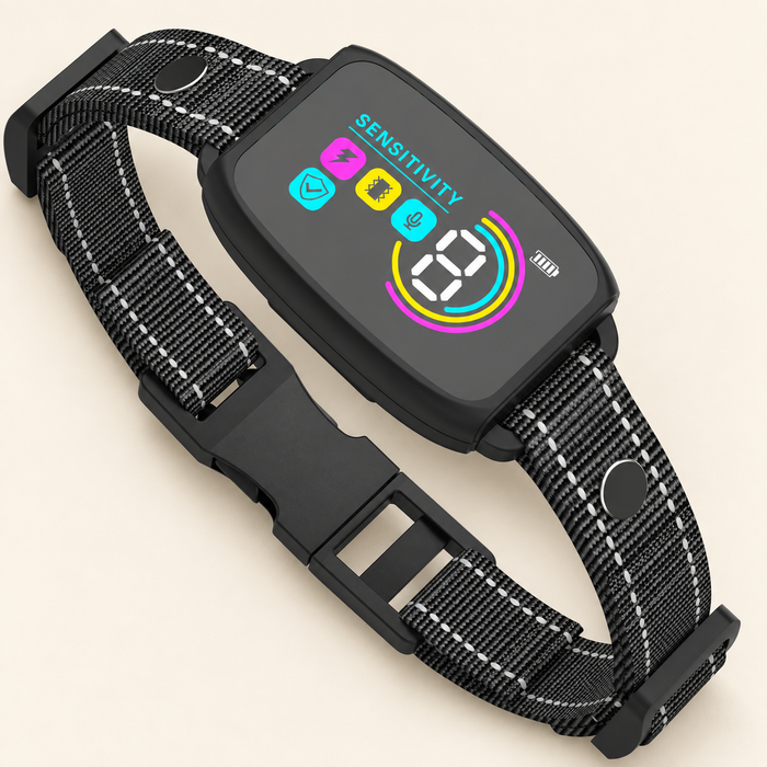 Black electronic dog collar with a colour display and woven strap on an ivory surface
